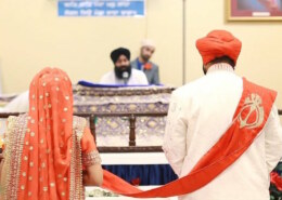 Why does the groom walk in front during the Anand Karaj?