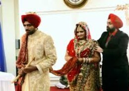 Yesterday at a wedding, I noticed the bride's brothers standing next to Guru Granth Sahib while she was taking the pheras. Who started this tradition, and what is the history behind it? Also, is this practice allowed in Sikhism? I personally didn't like it.